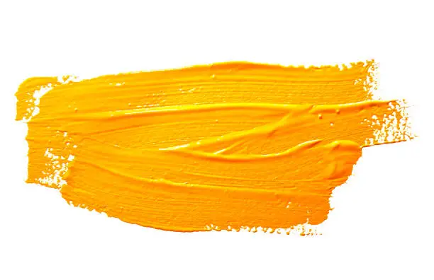 Yellow ochre strokes of the paint brush isolated on a white