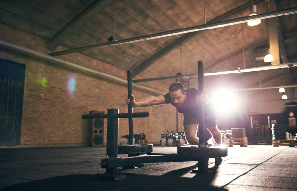 istock Sportive muscular man doing push-ups in gym 688001922