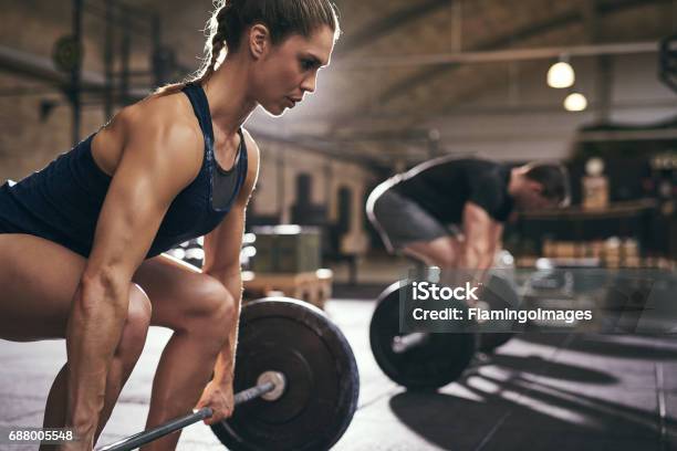 Sporty People Bend Their Knees Before Exercise Stock Photo - Download Image Now - Gym, Weight Training, Women