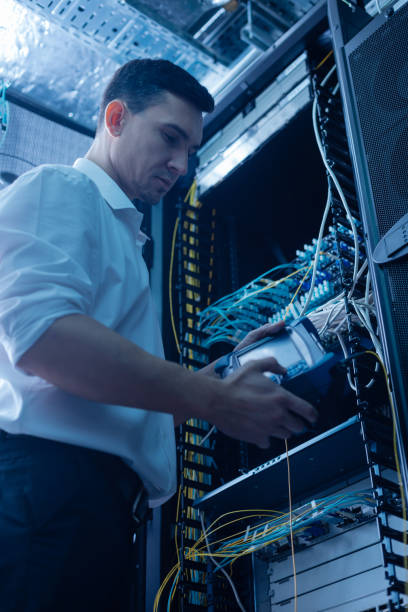 istock Serious male IT administrator working in the data center 688008196