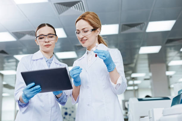 istock Positive delighted lab assistants looking downwards 688015704