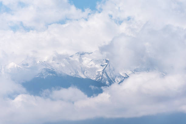 istock Ghostly mountain peak showing from a cloudy veil 688015762