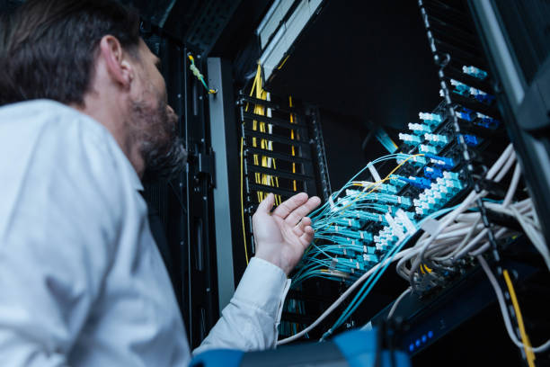 istock Professional male technician looking at the Ethernet cables 688015830