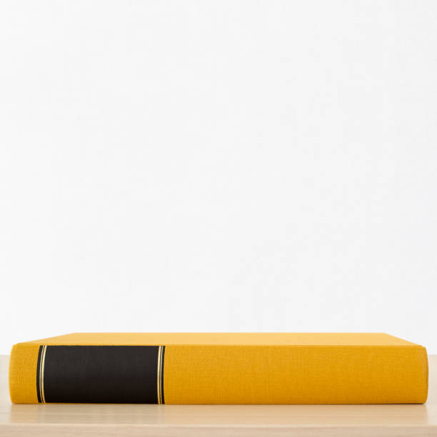 Yellow book with black frame on spine on the table