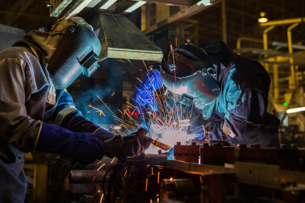 istock Team workers are welding steel part in factory 688019306