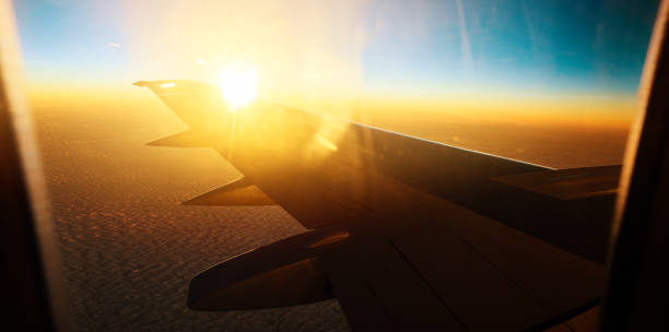 istock airplane wing in the sunset 688019374