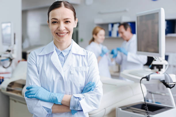 istock Positive delighted female lab assistant smiling on camera 688019566