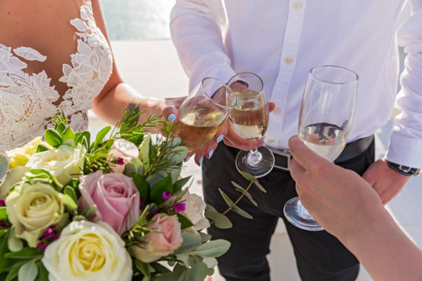 istock Flowers and wine glasses in the hands 688021960