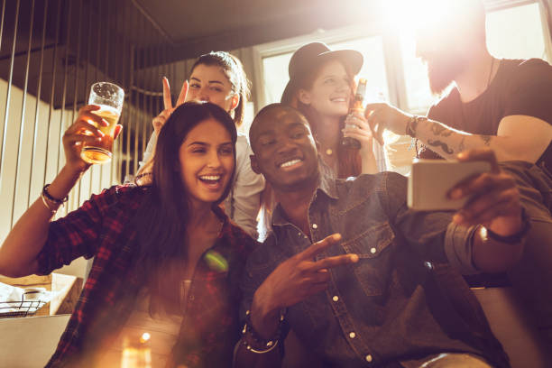 istock group of friends taking a selfie in a bar 688022086