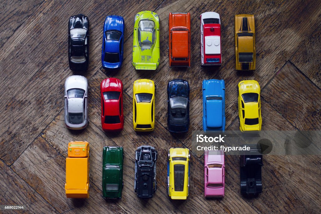 assorted colorful car collection on floor horizontal top view assorted metal colorful toy car collection on brown wooden floor in natural light Car Stock Photo