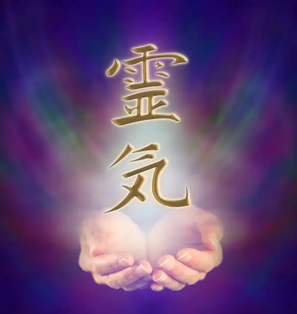 Healer's cupped hands and Reiki Kanji Symbol on misty dark blue background