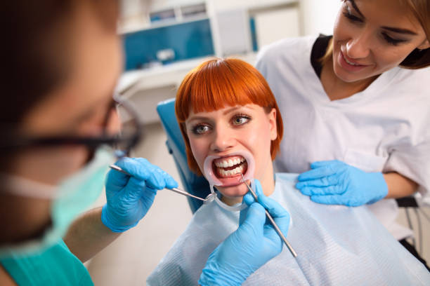 istock Young woman at dentist's office for routine checkup. 688023132
