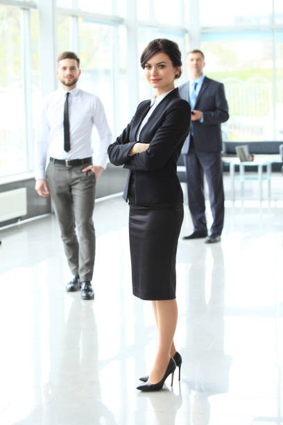 beautiful woman on the background of business people - concentration teacher business copy space imagens e fotografias de stock