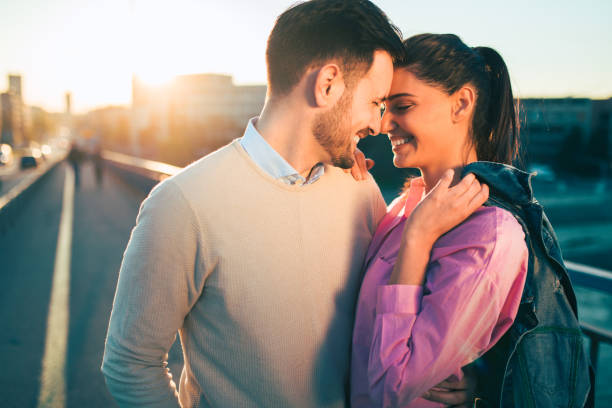 istock Young couple in love embracing on a bridge 688025868