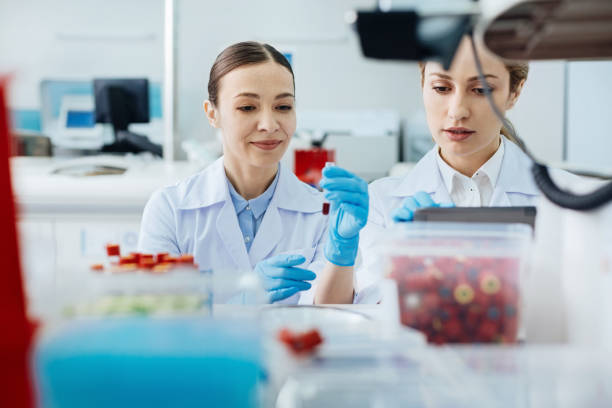 istock Positive delighted technician looking at test-tube 688026078