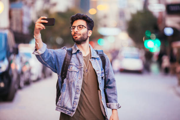 istock Young man taking self portrait with phone. Young hipster man 688030214