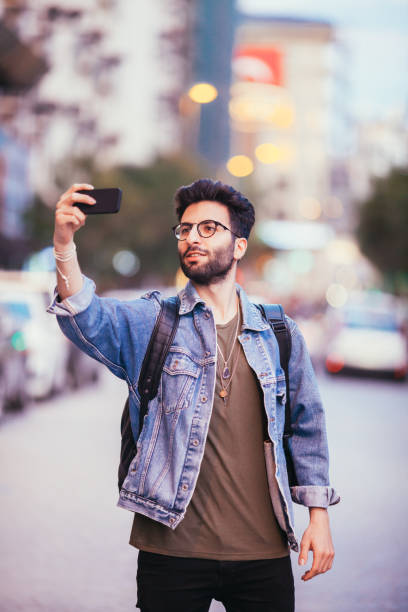 istock Young man taking self portrait with phone. Young hipster man 688030380