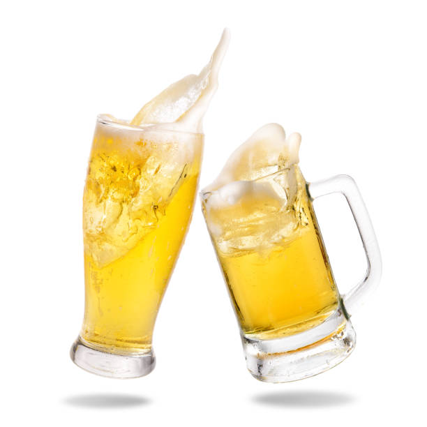 Cheering beer Cheers cold beer with splashing out of glasses on white background. beer glass splash stock pictures, royalty-free photos & images