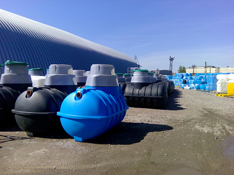 Septic tanks and other storage tanks in rows at the manufacturer factory depot