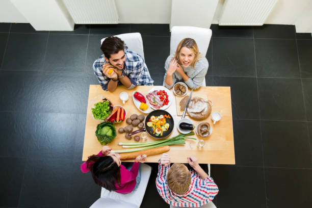 istock Group of young people having meal in the modern kitchen 688036972