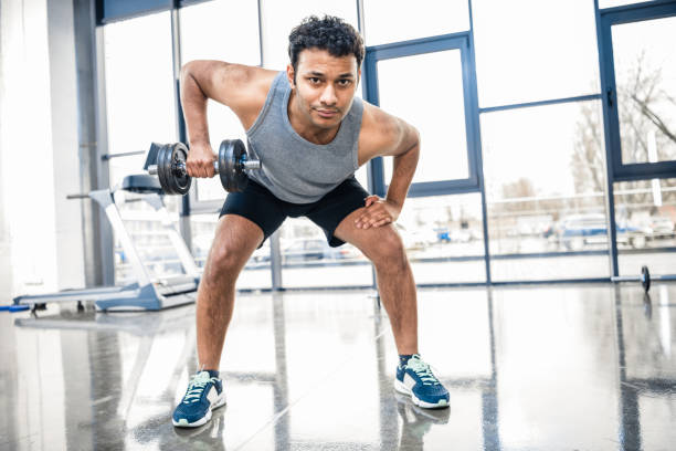 istock Handsome young man workout with dumbbell at gym 688038120