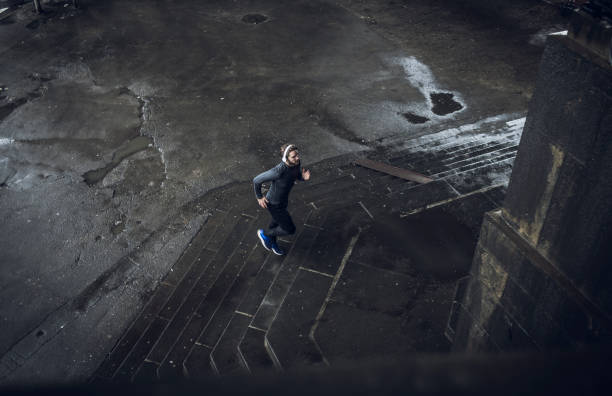 istock aerial view of a man running 688040328