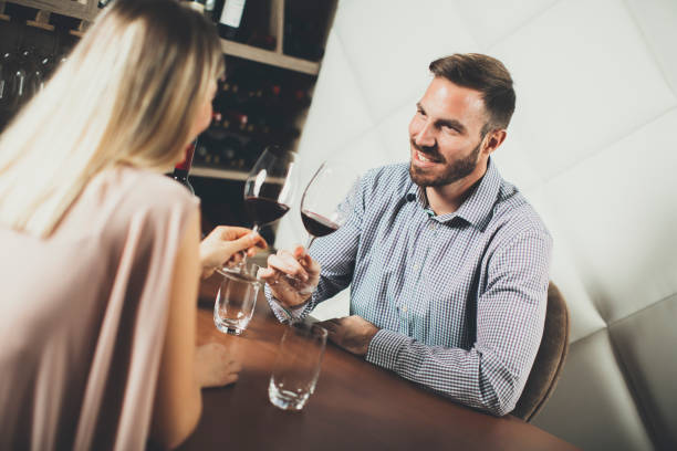 istock Handsome young couple on the date in wine bar 688041572