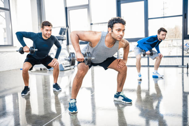 istock young men workout with dumbbells at gym 688041832