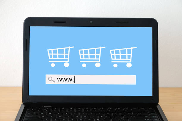 Lap-top computer with www. on search bar over blur store on screen background, online shopping concept, business and technology, template