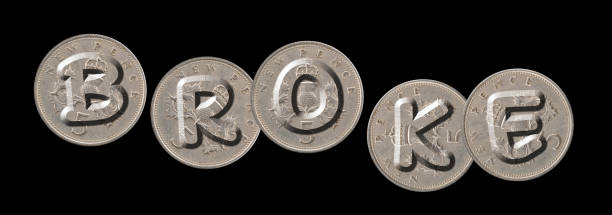 istock BROKE – Coins on black background 688046550