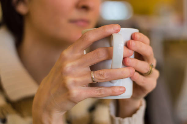 istock Delicate caucasian woman hands holding a white mug. 688047208
