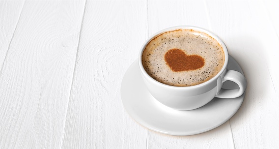 Cup of coffee on wooden background