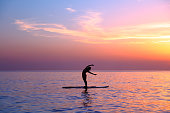 Yoga trainer over sunset background