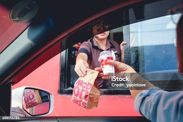 Bangkok Thailand Mar 4 2017 Customer Receiving Hamburger And Ice Cream After Order And Buy It From Mcdonalds Drive Thru Service Stock Photo - Download Image Now