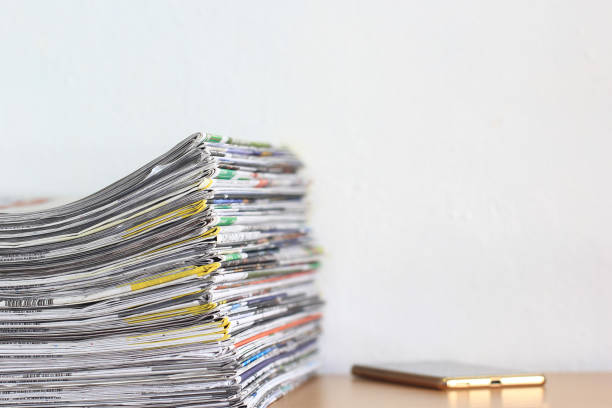 istock Close up stacking of Newspaper on wooden table, global communications concept 688057556