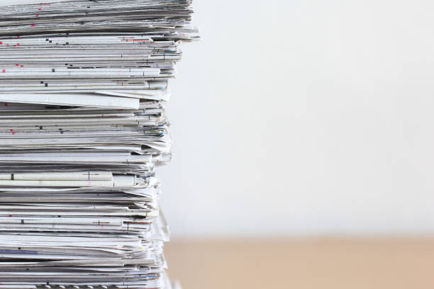 istock Close up stacking of Newspaper on wooden table, global communications concept 688057574