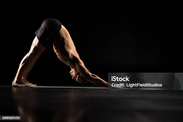 Man Standing In Yoga Position Stock Photo - Download Image Now - Active Lifestyle, Adults Only, Athlete