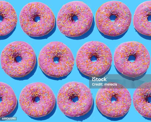 Pink Ring Doughnuts On Blue Background Stock Photo - Download Image Now - Pattern, Doughnut, Colored Background