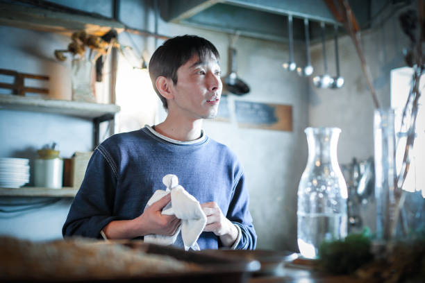 istock confident young male happy cafe owner 688064324