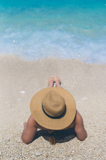 istock Woman in summer hat on beach 688067068