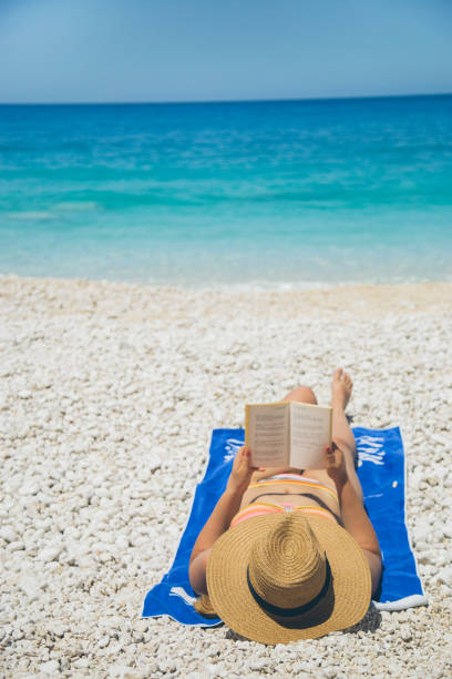istock Woman in summer hat on beach 688067886