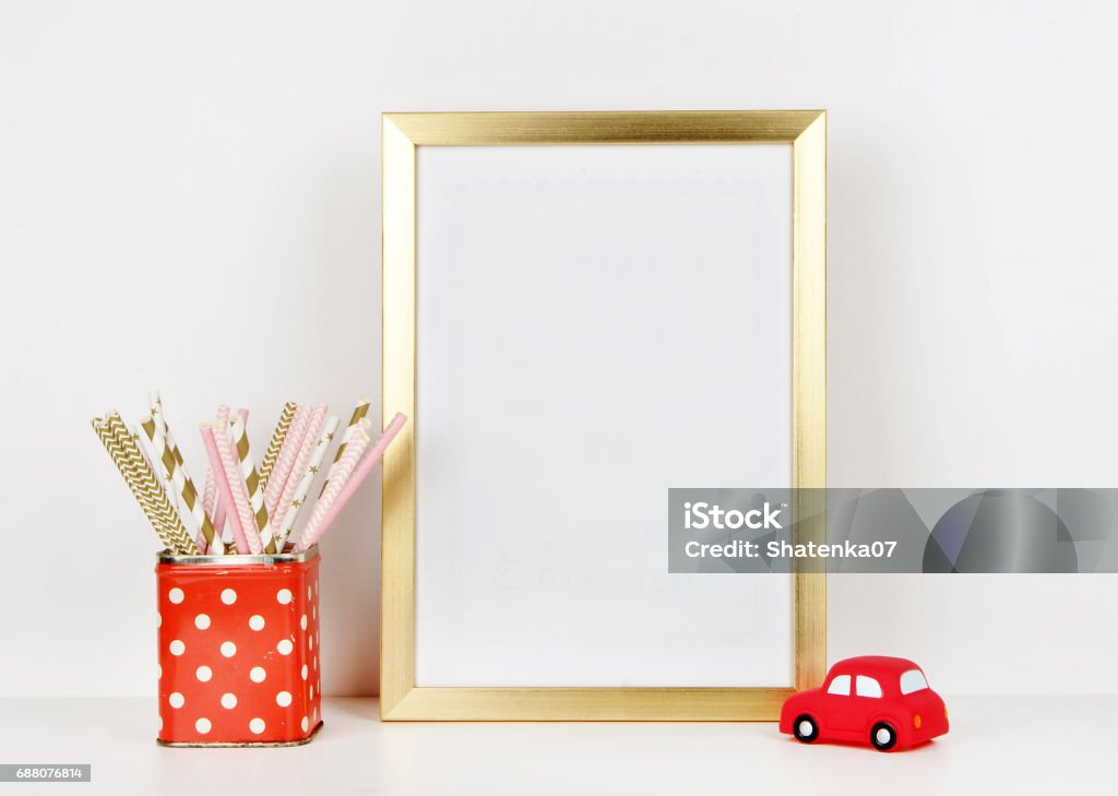 Gold frame mock up and toy red car, vase red and polka dots pattern. vintage Art Stock Photo