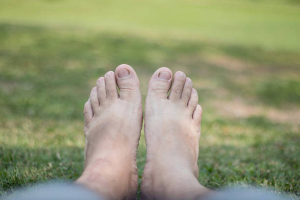 istock male's foot on green grass 688079624