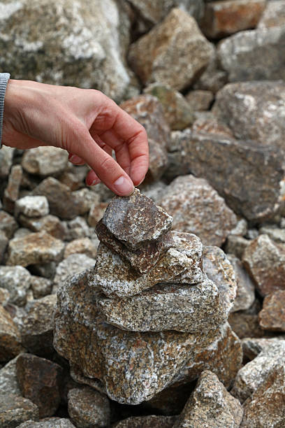 istock Cropped Hand Of Woman Adjusting Stone Stack 688080773