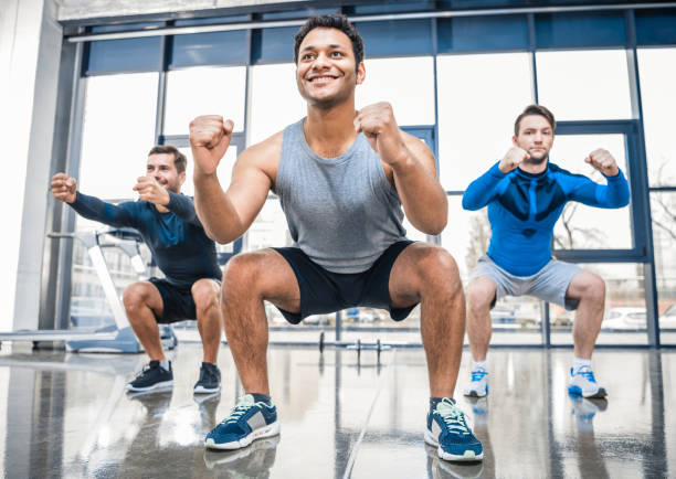 istock young men exercising at sports center 688081106