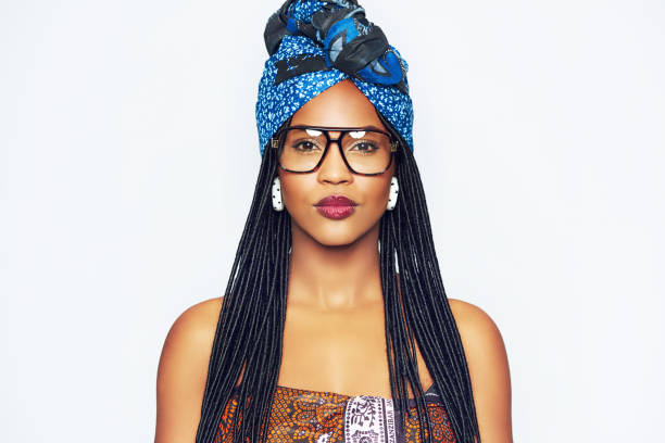 Fashionable black woman in ethnic clothes Head and shoulders portrait of fashionable young black woman in ethnic clothes with blue headscarf black woman hair braids stock pictures, royalty-free photos & images
