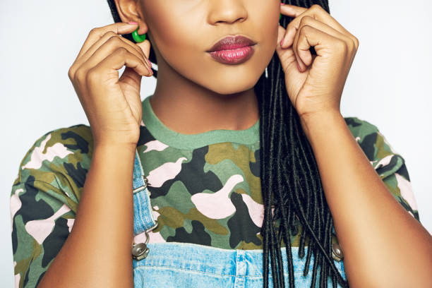 istock Young African woman adjusting her earrings 688095716