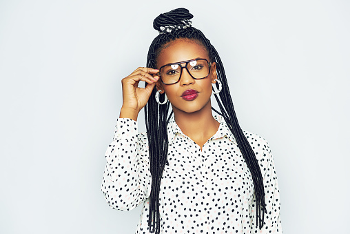 Head and shoulders portrait of fashionable black woman wearing glasses
