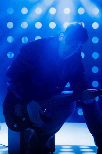 istock young rock musician playing electric guitar and singing 688104522