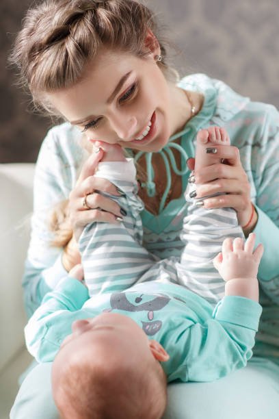 istock Newborn baby lying on his mother's lap 688106928